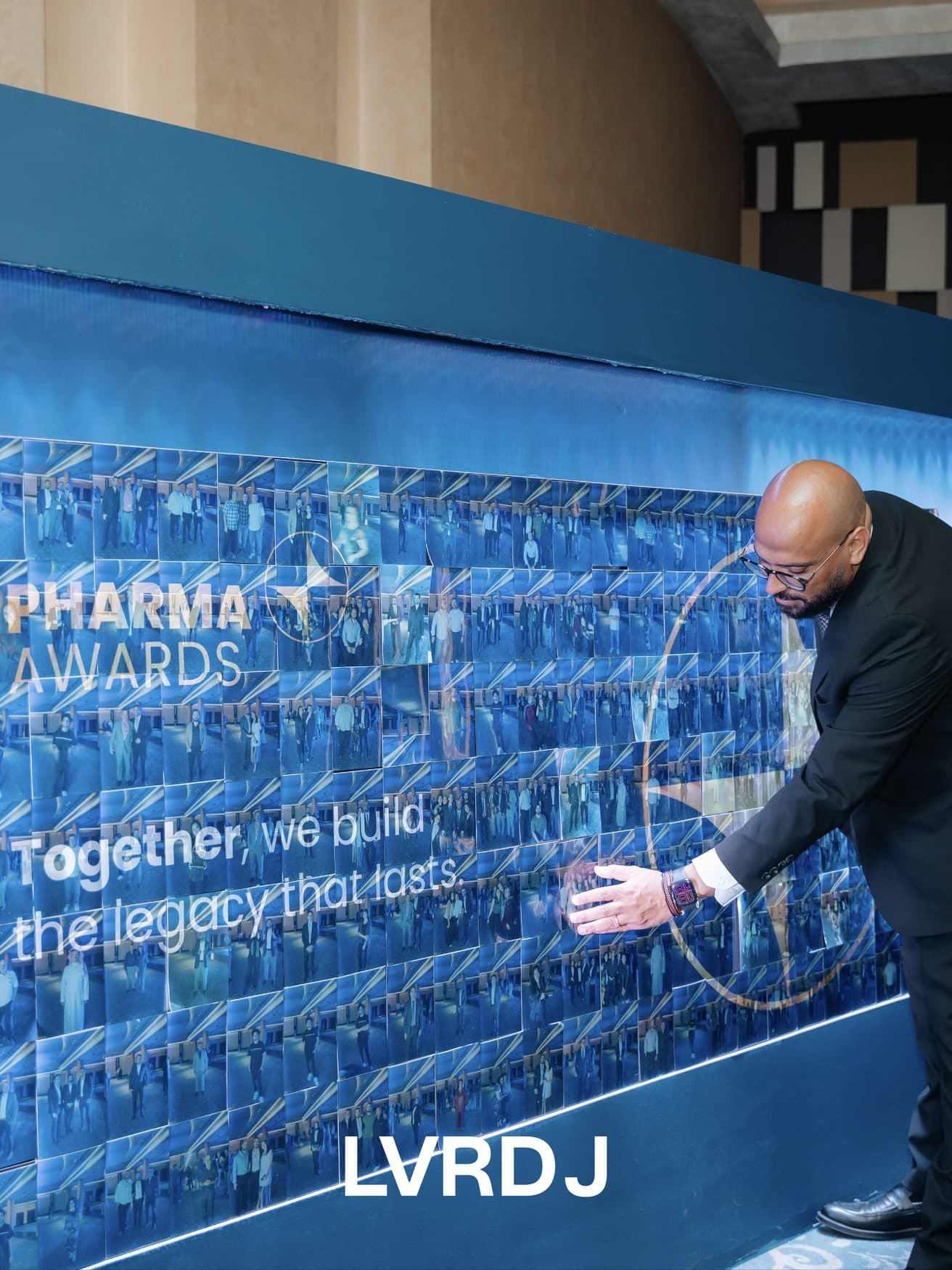 Guest adding to the 'Together we build the legacy' wall