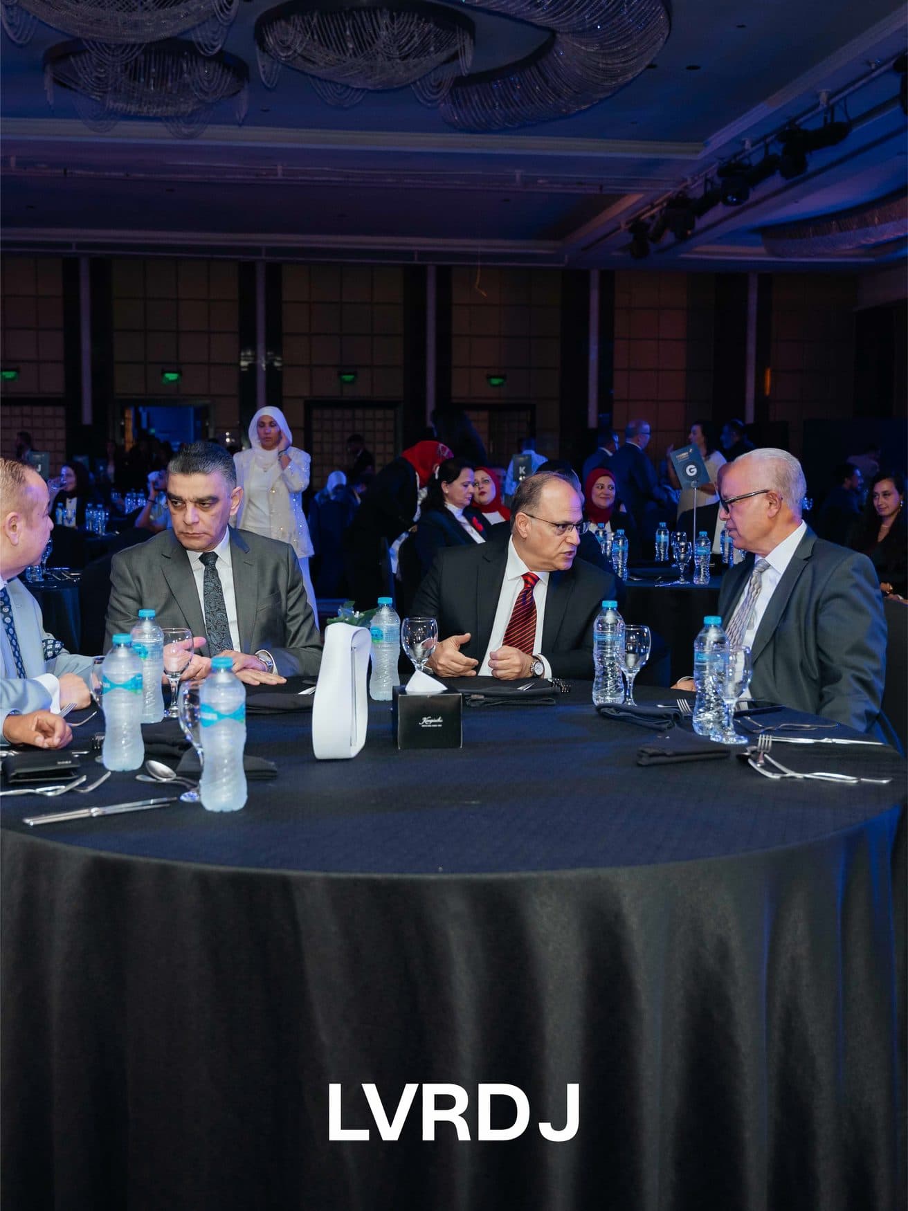 Guests seated at a round table during the ceremony